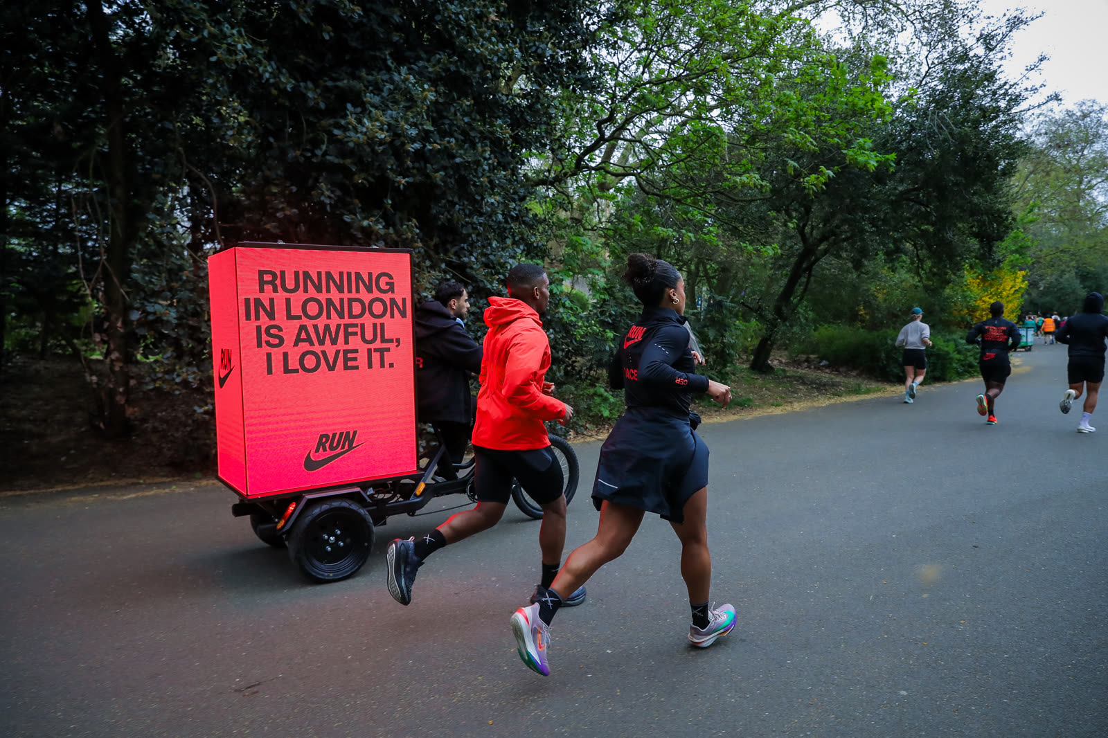AdBike pacing the Nike run pack through Hyde Park with the RUN screen glowing